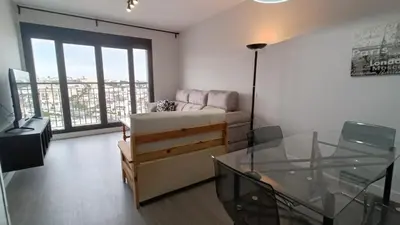 a living room with a couch and a glass table at Kiana Mirador Sherry, parking gratis in Jerez de la Frontera