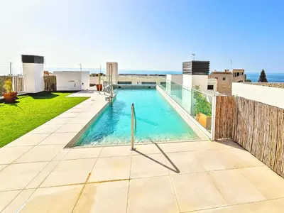 a swimming pool on the roof of a house at Oceanfront Duplex with a Rooftop Pool and Terrace in El Puerto de Santa María