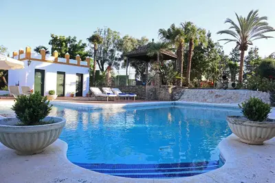 a swimming pool in front of a villa at Finca La Fuensanta in Arcos de la Frontera