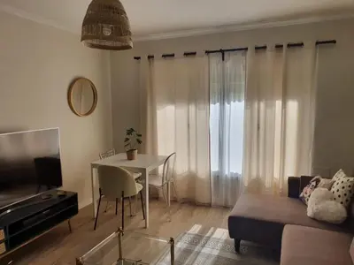 a living room with a table and a couch at Apartamento Juan Belmonte in Jerez de la Frontera