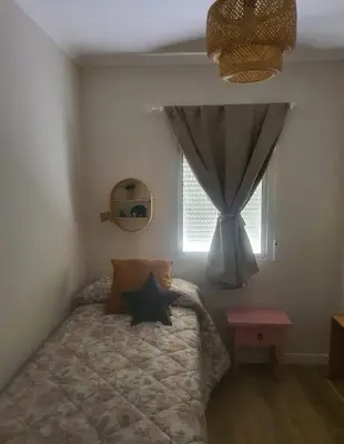 a bedroom with a bed and a window at Apartamento Juan Belmonte in Jerez de la Frontera