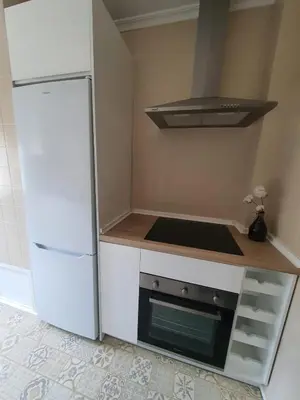 a kitchen with a white refrigerator and a stove at Apartamento Juan Belmonte in Jerez de la Frontera