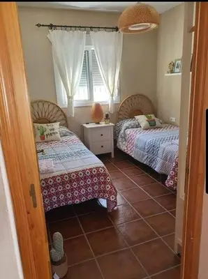 a bedroom with two beds and a window at Orchard View in Campano