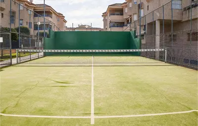 a tennis court with a net on top of it at Pet Friendly Apartment in Sanlúcar de Barrameda