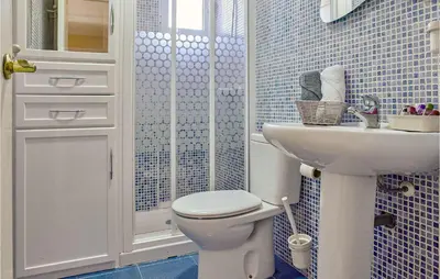 a bathroom with a toilet and a sink at Pet Friendly Apartment in Sanlúcar de Barrameda