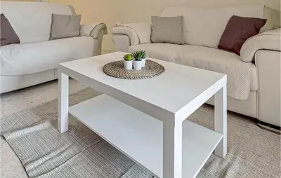 a white coffee table in a living room with a couch at Pet Friendly Apartment in Sanlúcar de Barrameda