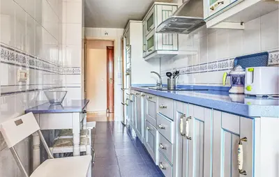 a kitchen with blue cabinets and blue counter tops at Pet Friendly Apartment in Sanlúcar de Barrameda