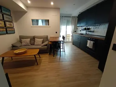 a living room with a couch and a table at Apartamento Arsenio Beach in Cádiz