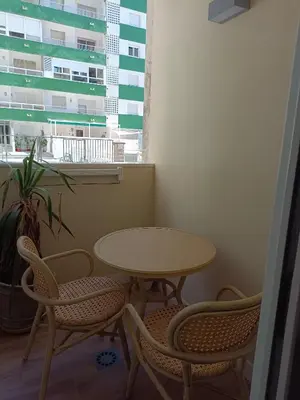 a table and chairs in a room with a window at Apartamento Arsenio Beach in Cádiz