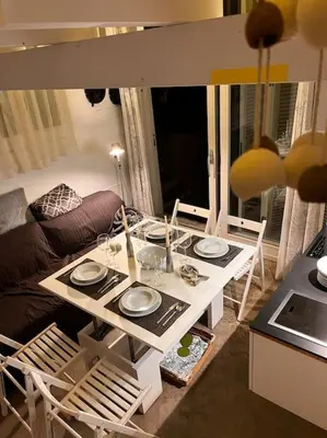 a living room with a table with plates on it at Casa de invitados, a pie de playa, en La Torre Verde in El Puerto de Santa María