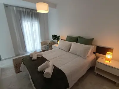 a bedroom with a large bed with towels on it at Casa Palacio Arcos del Carmen in Jerez de la Frontera