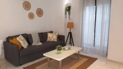 a living room with a couch and a table at Casa Palacio Arcos del Carmen in Jerez de la Frontera