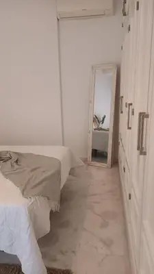 a white room with a bed and a mirror at Casa Palacio Arcos del Carmen in Jerez de la Frontera