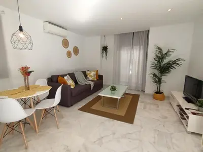 a living room with a couch and a table at Casa Palacio Arcos del Carmen in Jerez de la Frontera