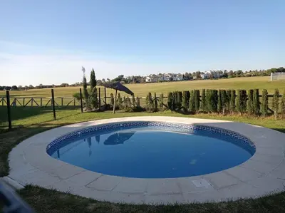 a swimming pool in the middle of a yard at Costa Ballena Torresalada 1 in Costa Ballena
