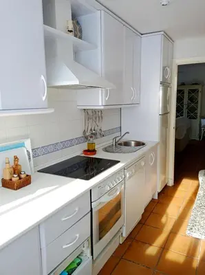 a white kitchen with white cabinets and a sink at Costa Ballena Torresalada 1 in Costa Ballena