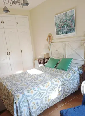 a bedroom with a bed with green pillows at Costa Ballena Torresalada 1 in Costa Ballena
