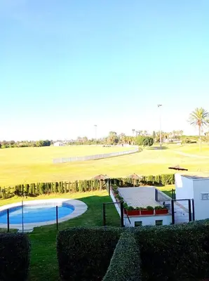a view of a golf course with a swimming pool at Costa Ballena Torresalada 1 in Costa Ballena