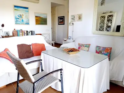 a living room with a white table and a couch at Costa Ballena Torresalada 1 in Costa Ballena