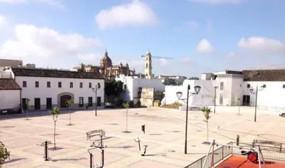 a large parking lot in a city with buildings at La Bodeguita in Jerez de la Frontera