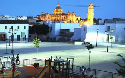 a park with a playground with a building in the background at La Bodeguita in Jerez de la Frontera