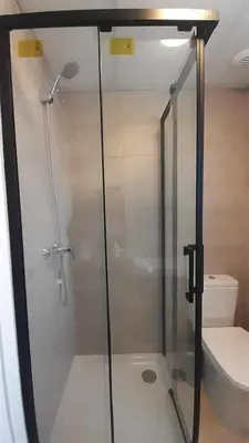 a bathroom with a glass shower with a toilet at Casa Carivid - en el centro y con parking gratis - in Sanlúcar de Barrameda