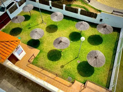 an overhead view of a park with umbrellas in the grass at MyChoice Aitana in Rota