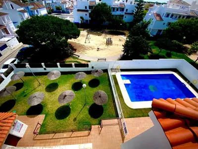 an aerial view of a yard with umbrellas and a swimming pool at MyChoice Aitana in Rota