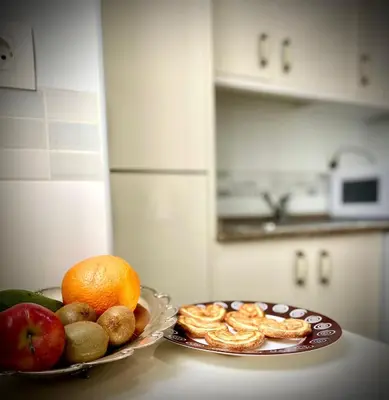 a plate of fruit and snacks on a counter in a kitchen at MyChoice Aitana in Rota