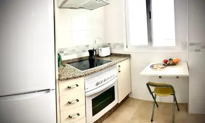 a white kitchen with a sink and a counter at MyChoice Aitana in Rota
