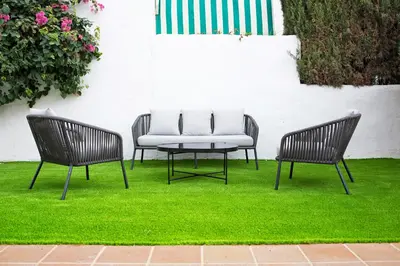 two chairs and a table on some grass at MARIA DEL MAR SEA APARTMENT in Chiclana de la Frontera