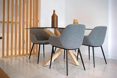 a dining room table with two chairs and a vase at MARIA DEL MAR SEA APARTMENT in Chiclana de la Frontera