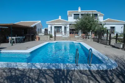 a swimming pool in front of a house at Villa Encanto in Conil de la Frontera