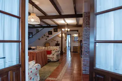 a hallway with couches and a table in a house at Villa Encanto in Conil de la Frontera