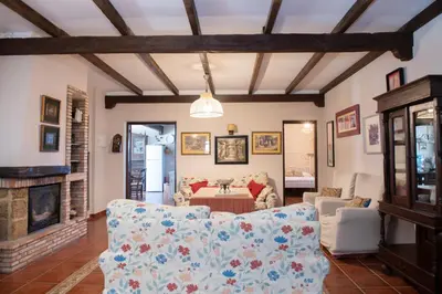 a living room with a couch and a fireplace at Villa Encanto in Conil de la Frontera