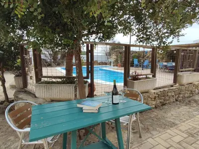 a blue table with a bottle of wine and a glass at Villa Encanto in Conil de la Frontera