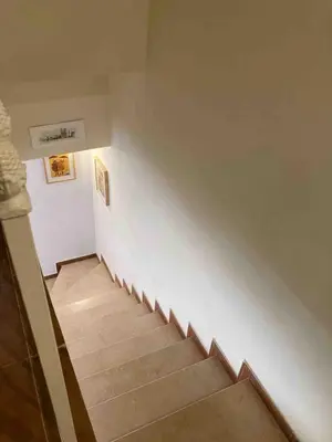 a stairway with a white wall and a stair case at Villa Bosque Novo Sancti petri Grupo AC Gestión in Chiclana de la Frontera