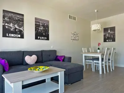 a living room with a couch and a table at Apartamento Sheris - Ole Solutions in Jerez de la Frontera