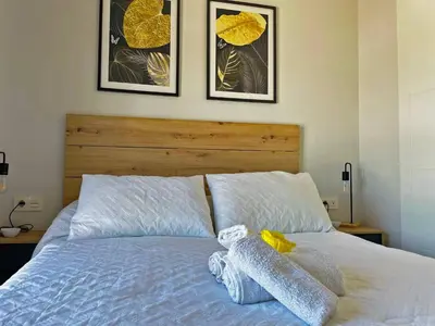 a bed with a stuffed animal on top of it at Apartamento Sheris - Ole Solutions in Jerez de la Frontera