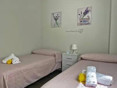 a room with two beds with towels on them at Apartamento Sheris - Ole Solutions in Jerez de la Frontera