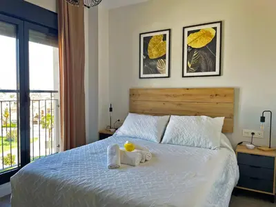 a bedroom with a bed with a stuffed animal on it at Apartamento Sheris - Ole Solutions in Jerez de la Frontera
