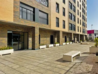 a brick building with benches in front of it at Apartamento Sheris - Ole Solutions in Jerez de la Frontera