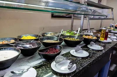 a buffet with many bowls of food on a table at Hotel Caribe in Rota