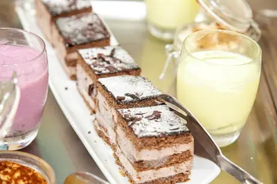a plate of desserts on a table with drinks at Hotel Caribe in Rota