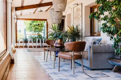 a living room with a couch and a table with plants at Puerta de Algadir in El Puerto de Santa María