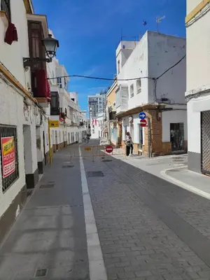 an empty street in a city with buildings at Estudio Alicia in Rota