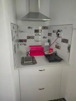 a kitchen counter with a sink and a stove at Estudio Alicia in Rota