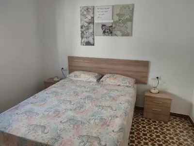 a bedroom with a bed and two night stands at Estudio Alicia in Rota