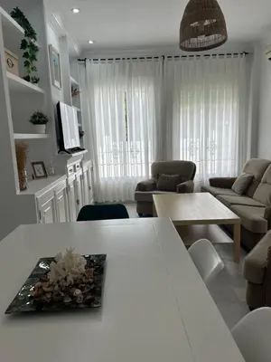 two beds in a room with white walls at VILLA SALMONETE in Sanlúcar de Barrameda