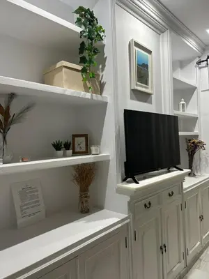 a bedroom with a bed and a large window at VILLA SALMONETE in Sanlúcar de Barrameda